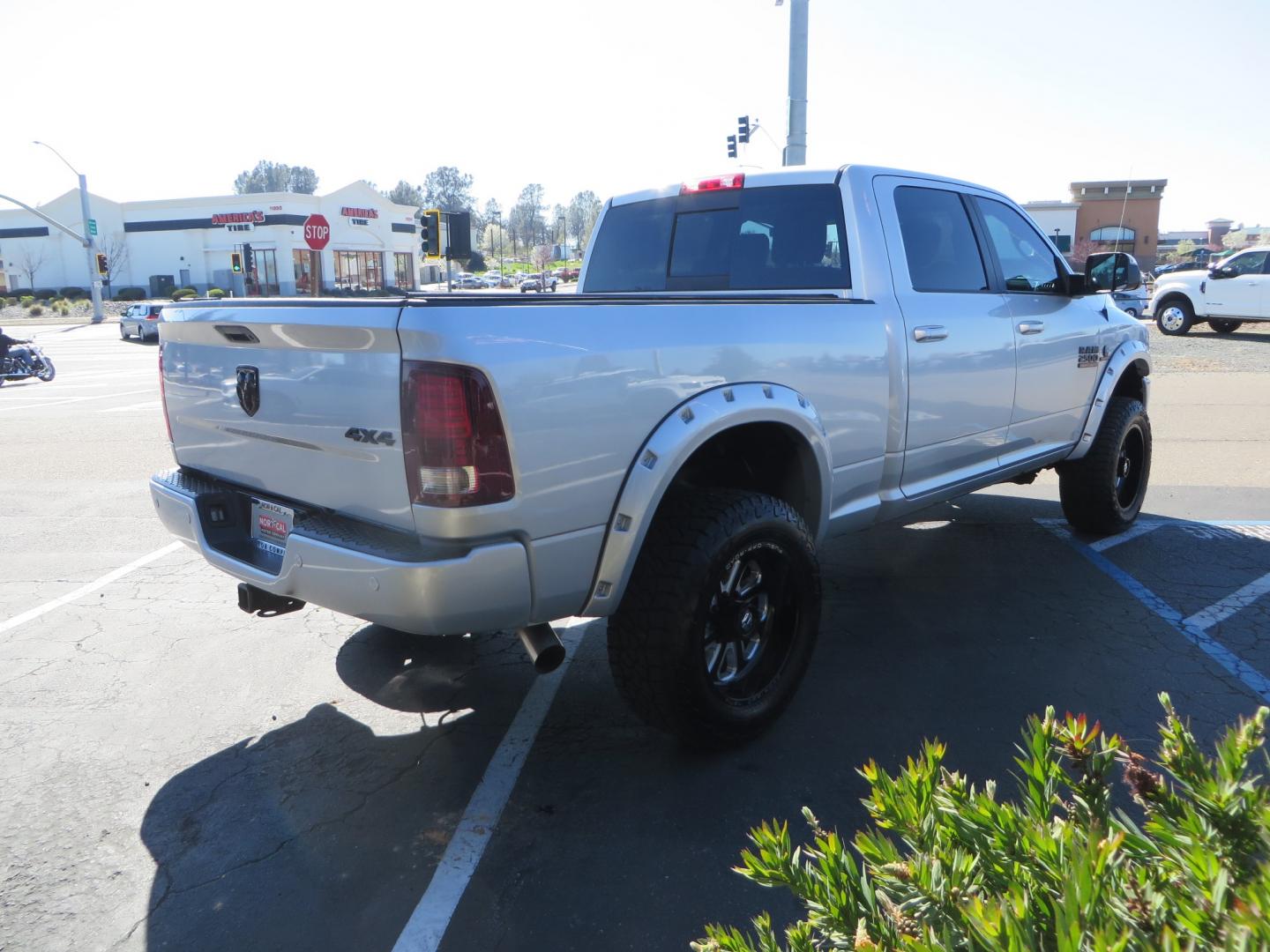 2016 SILVER /BLACK RAM 2500 Laramie Crew Cab SWB 4WD (3C6UR5FL3GG) with an 6.7L L6 OHV 24V TURBO DIESEL engine, 6A transmission, located at 2630 Grass Valley Highway, Auburn, CA, 95603, (530) 508-5100, 38.937893, -121.095482 - Leveled Ram sitting on Fuel Offroad wheels, Falken Wildpeak AT tires, Amp Power steps, Rolling Bed cover, Color matched fender flares, and window tint. - Photo#4